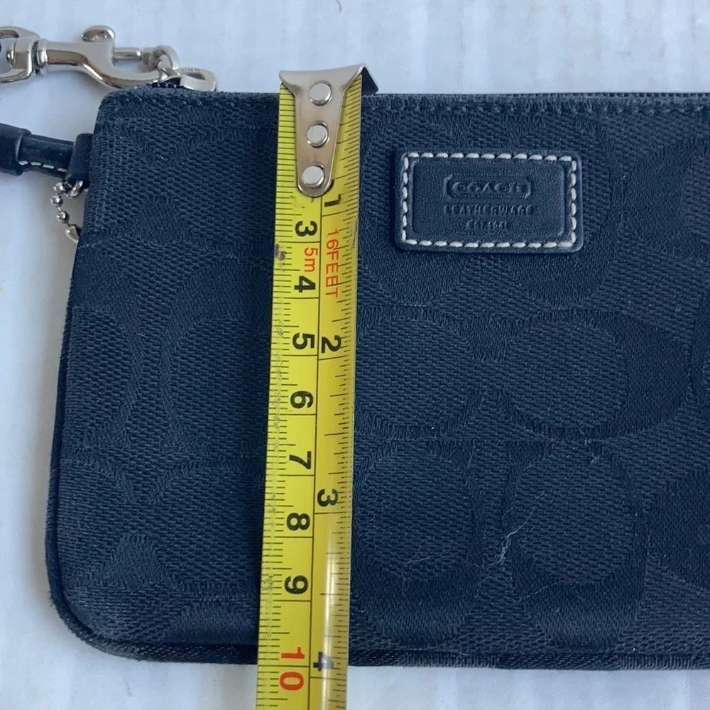 Coach black signature C mini wristlet.